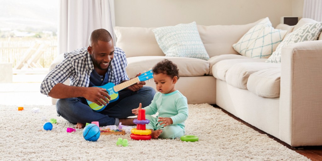 Father and son playing with toys on the ground