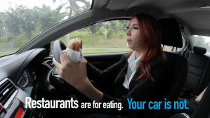 Woman driving with a donut